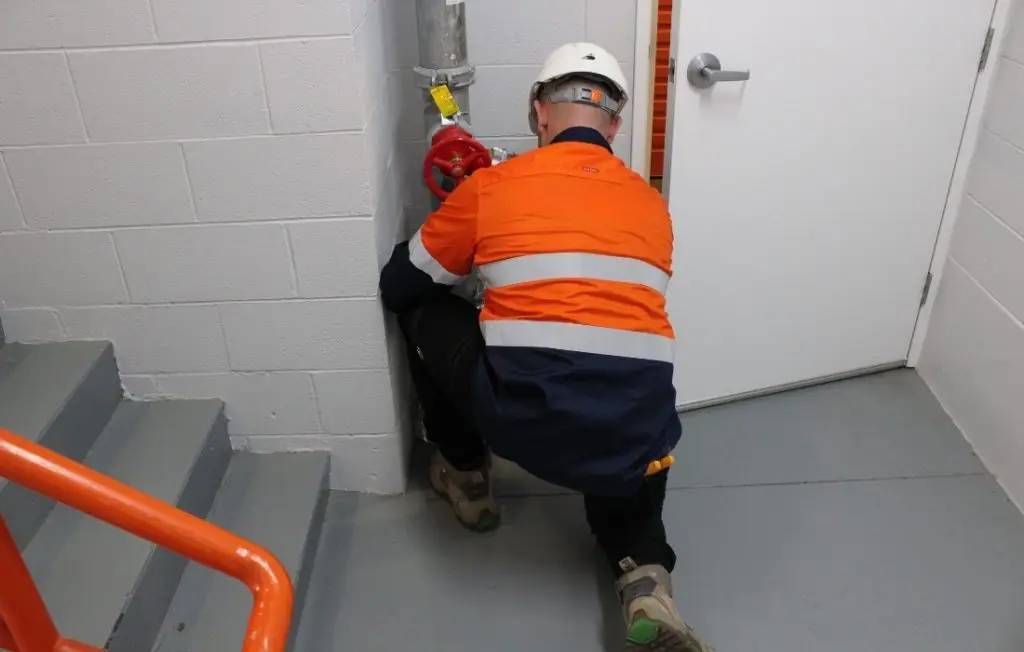 Inspecting and testing fire equipment at a building located in Liverpool